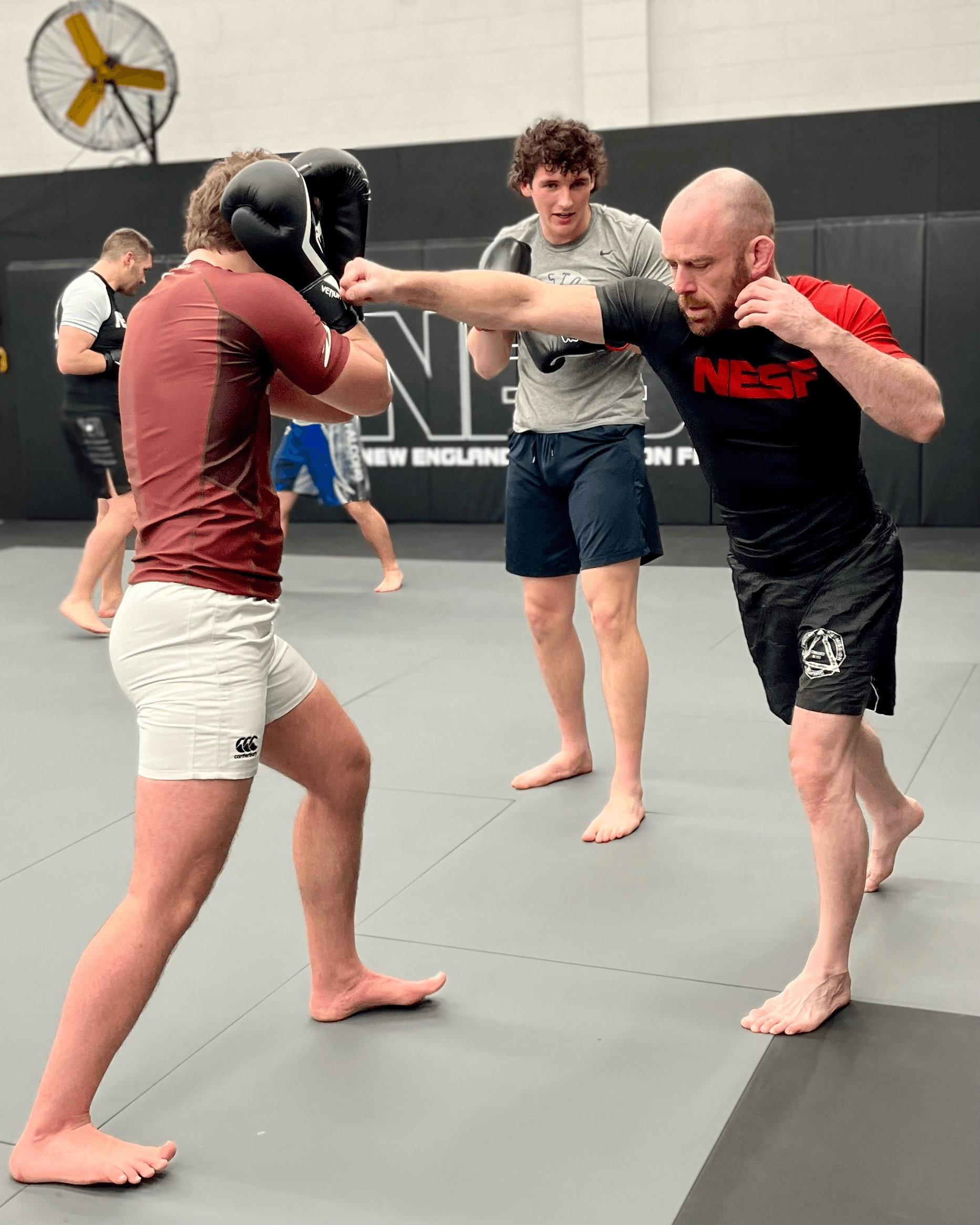 Head instructor teaching students to strike