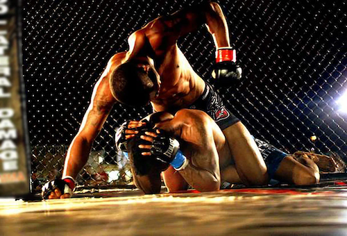 Photo of MMA fighters using Jiu-Jitsu techniques on the ground during an MMA fight.